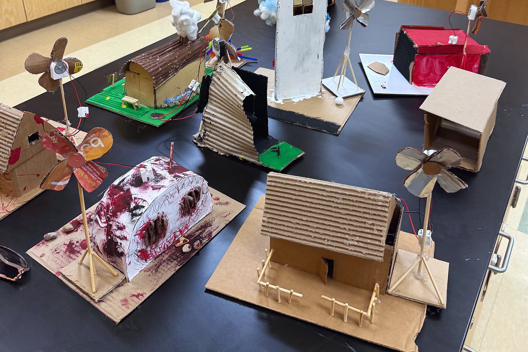 Cardboard houses with working wind turbines, built from recycled materials