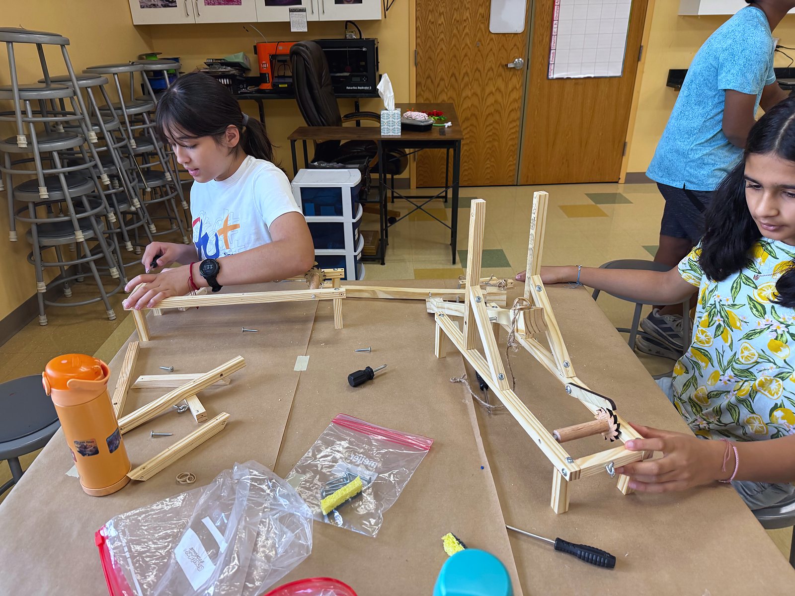 A team building their catapult, one arm at a time